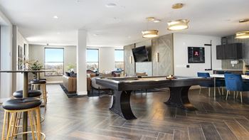 A modern dining room with a large table and chairs.
